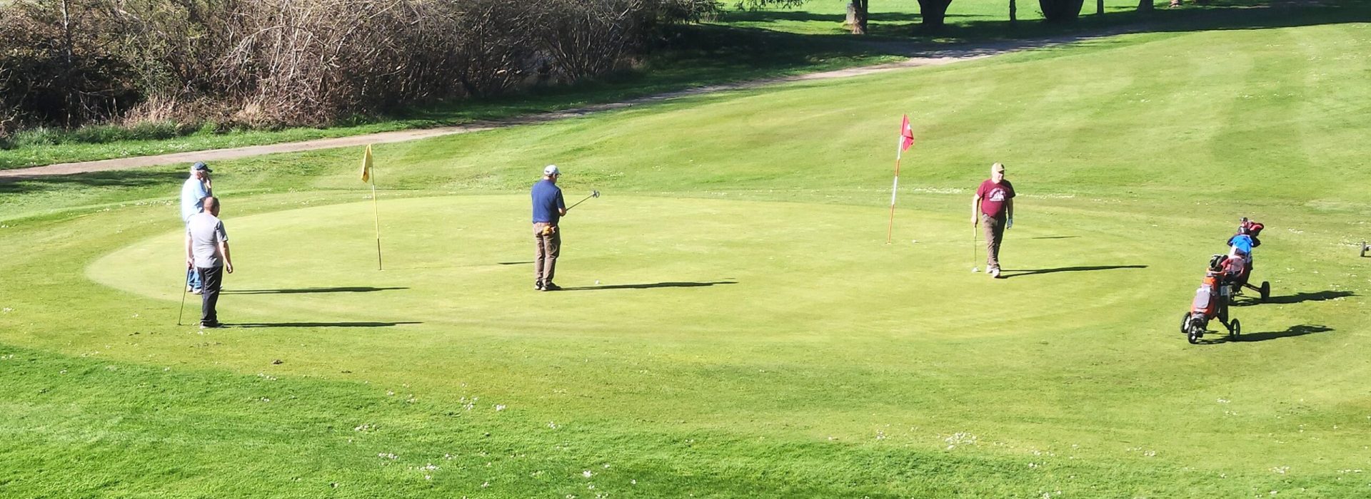 Golfers on the Cedar Bend Golf Course green