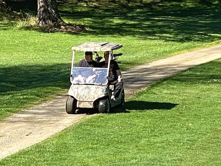 Golfers on golf cart